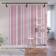 a pink and white striped wallpaper in a living room with a ladder to the ceiling