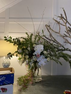 a vase filled with white and pink flowers on top of a table