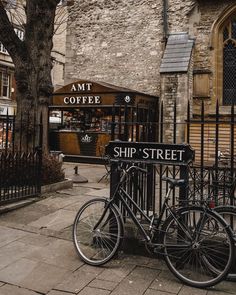 two bikes parked next to each other in front of a building