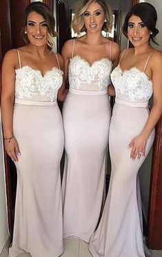 the bridesmaids are posing for pictures in their wedding gowns, and one is wearing