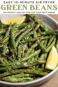 green beans in a bowl with lemon wedges