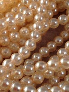 some white pearls are laying on top of each other in this close up photo,