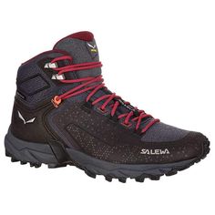 a pair of hiking shoes with red laces on the outstep and black upper part