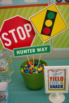 a table topped with lots of candy next to a stop sign and hunter way sign