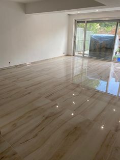 an empty room with marble floors and sliding glass doors