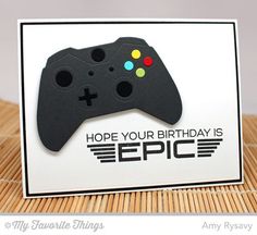 a close up of a card with a video game controller on it's side