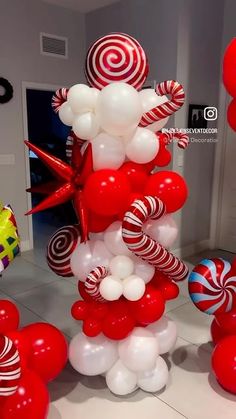 red and white balloons are in the shape of a christmas tree with candy canes