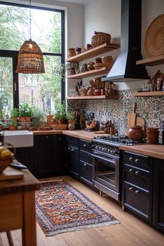 a kitchen filled with lots of counter top space next to a stove top oven under a window