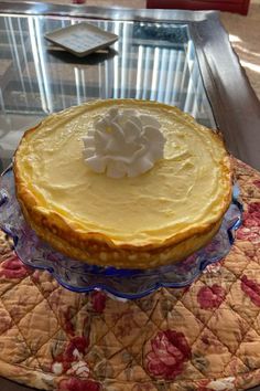 a pie sitting on top of a glass cake plate