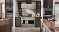 a modern kitchen with stainless steel appliances and wood flooring