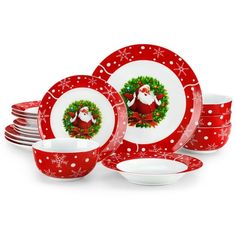 a red and white christmas dinner set with santa clause on the front, surrounded by snowflakes