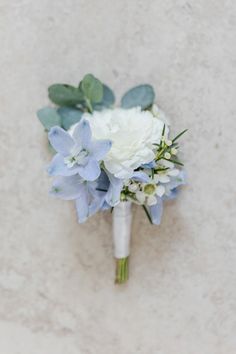 a bridal bouquet with blue and white flowers