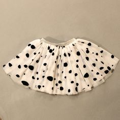 a white skirt with black dots on it