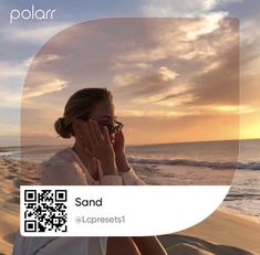 a woman sitting on top of a beach next to the ocean