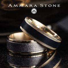 two black and gold wedding bands on top of each other