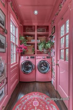 a pink washer and dryer in a room with pictures on the wall above it