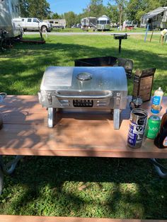 an outdoor bbq grill sitting on top of a picnic table