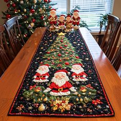 a christmas table runner with santa and other decorations