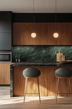 two stools are in front of an island with green marble countertops and wooden cabinets