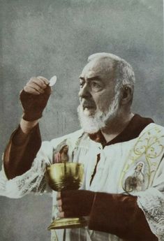 an old man holding a gold cup and a spoon in his right hand while wearing a priest's outfit