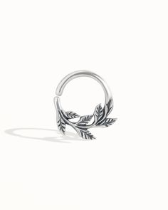 a silver ring with leaves on it