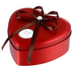 a red heart shaped box with a brown ribbon