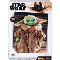 the star wars yoda and baby yoda cross stitch pattern is shown in a box