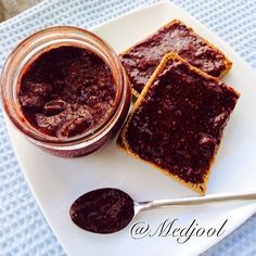 peanut butter and jelly spread on top of toasted bread with a spoon next to it