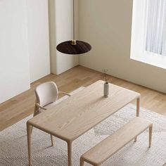 a wooden table sitting on top of a white rug