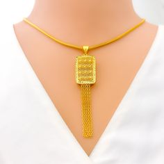 This 22k gold pendant, weighing 5.5 grams, features a luminescent rectangular design that exudes elegance and sophistication. The yellow gold finish enhances its luxurious and radiant appearance. Measuring 2.8 inches in length, this pendant is perfect for adding a touch of refined beauty to any necklace chain (chain not included). Ideal for those who appreciate exquisite craftsmanship and timeless style, this stunning pendant is a standout addition to any jewelry collection. PRODUCT DETAILS Gold Traditional Gold Rectangular Necklace, Elegant Yellow Rectangular Necklaces, Elegant Yellow Rectangular Necklace, Bridal Jewelry Necklace, Precious Stones Rings, Diamond Pendant Sets, Modern Bracelets, Fancy Necklace, Mens Gold Rings