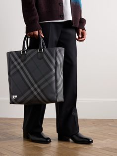 Burberry's tote bag is perfectly sized to fit the essentials for long work commutes or overnight trips.Topped with sturdy handles, it's jacquard-woven with the house's signature checks and features an internal zipped pocket to keep smaller items organised. There's enough space for a change of clothes plus a laptop and water bottle. Use the optional shoulder strap to wear it cross-body. Business Coated Canvas Shoulder Bag With Handles, Business Shoulder Bag In Coated Canvas With Handles, Business Shoulder Bag In Coated Canvas, Business Shoulder Bag With Coated Canvas, Designer Double Handle Bags For Business Trips, Designer Coated Canvas Bag For Work, Business Briefcase With Dust Bag, Tote Style, Designer Tote Bags For Business Trips, Business Trip Bags With Detachable Double Handle