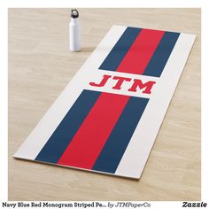 a pink, blue and white towel with the word jtmm on it next to a water bottle