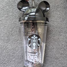 a starbucks cup with mickey mouse ears on it