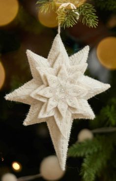 a white ornament hanging from a christmas tree