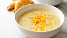 there is a bowl of soup with cheese in it