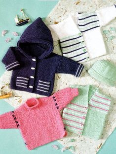 knitted sweaters and mittens laid out on a table