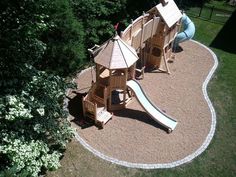 an aerial view of a playground with a slide and play set in the middle of it