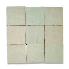 several square tiles are arranged together on a white surface