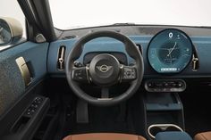 the interior of a car with steering wheel and dashboard