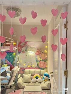 a living room filled with furniture and lots of pink hearts