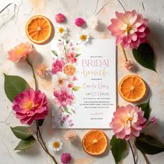 an orange and flower bridal party card surrounded by pink flowers, orange slices and leaves