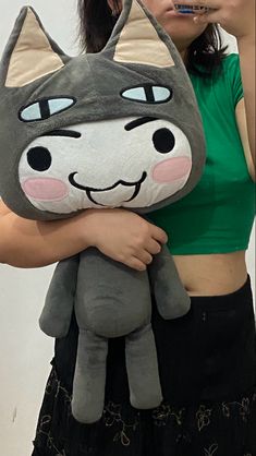 a woman holding a stuffed animal in front of her face