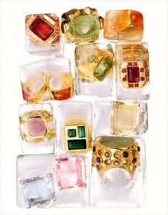 many different colored stones and rings in ice cubes on a white background with watercolor