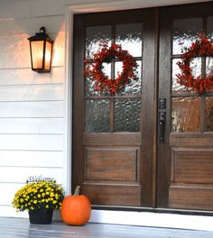 the front door is decorated with wreaths and flowers