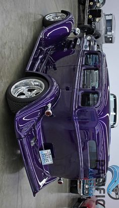 a purple car is parked next to other cars