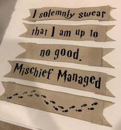 three burlap banners with black ink saying i solemnly swear that i am up to no good mischef managed