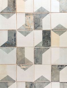 an old tile wall with several different colored arrows