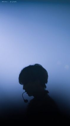 the silhouette of a person wearing a headset