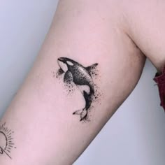 an orca whale tattoo on the arm