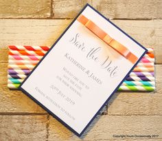 an orange ribbon on top of a wedding save the date card next to colored straws